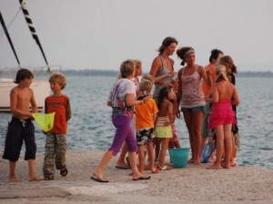 kinderen (groot en klein) vermaken zich in de haven